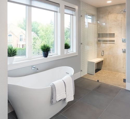bathroom with freestanding tub and walk in shower