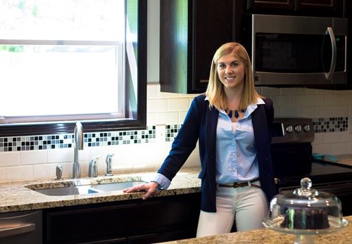 kitchen designer standing next to a kitchen faucet